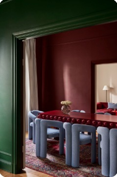 Dining room with saturated green and sculptural furniture