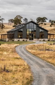 Black-framed barn home in open countryside
