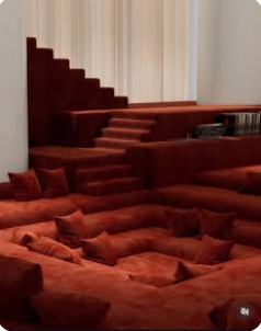 Layered, built-in lounge in warm clay tones