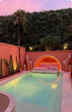 Pink courtyard pool and sculptural seating