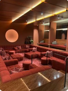 Expressive red lounge with sculptural lighting